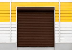 Brown roller shutter with orange and white venetian blind in the background